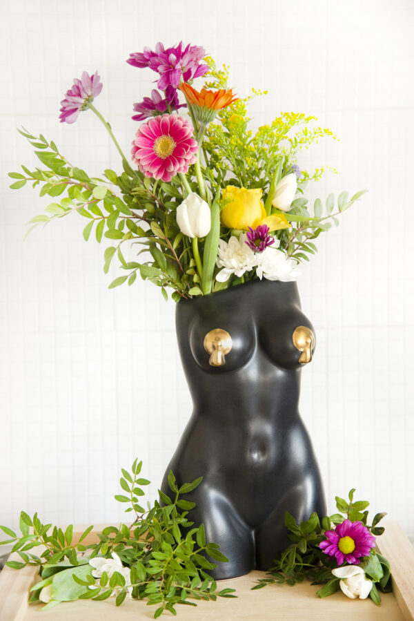Black femme vase with bright spring flowers