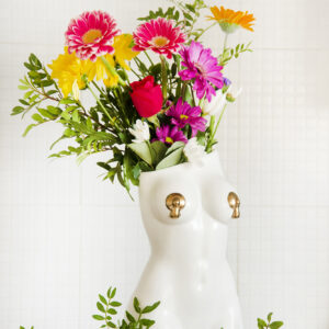 White femme vase with bright spring flowers
