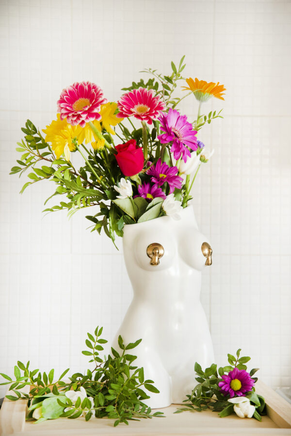 White femme vase with bright spring flowers