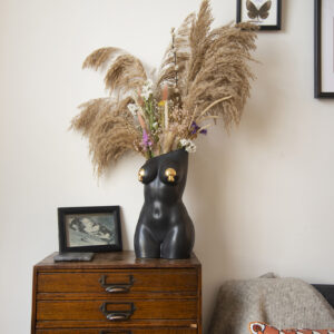 Black femme vase in styled setting with dried floral arrangement